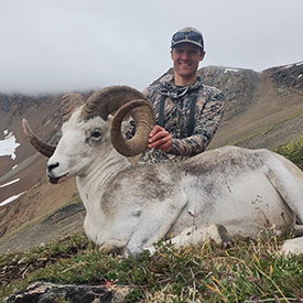 Hunter holding a Stone's sheep